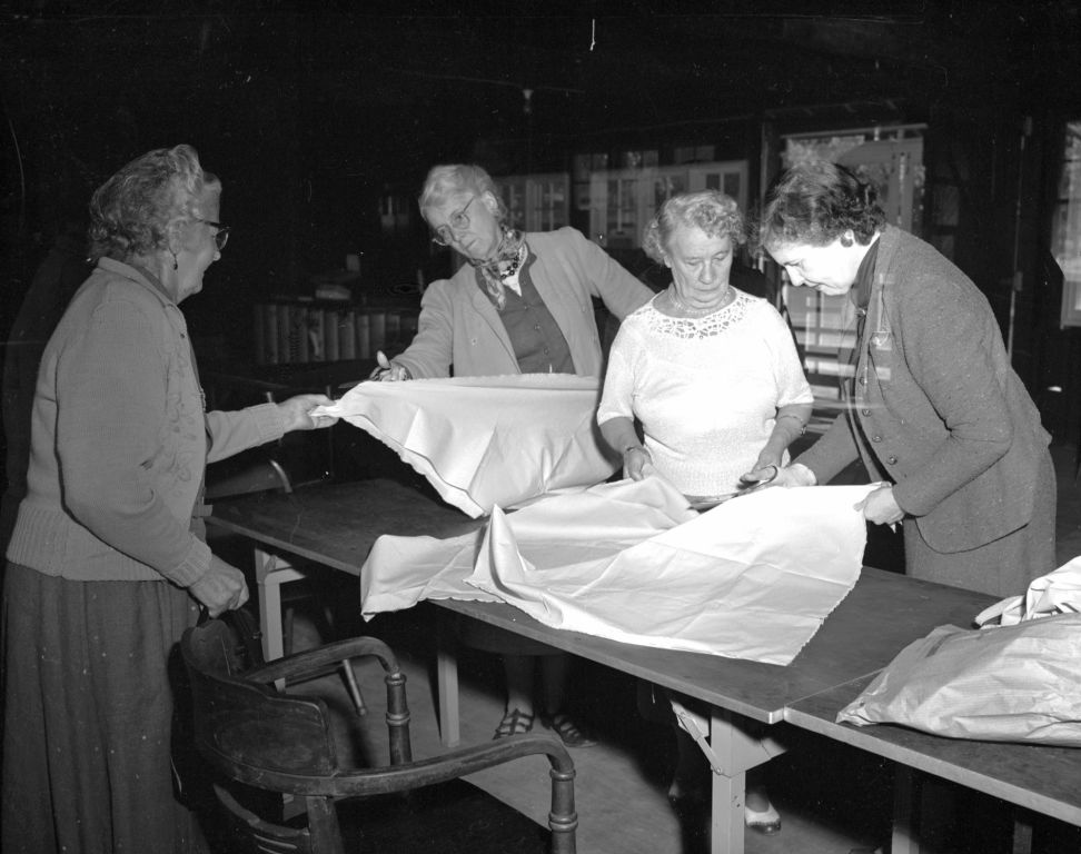 Women Preparing a Large Map or Fabric